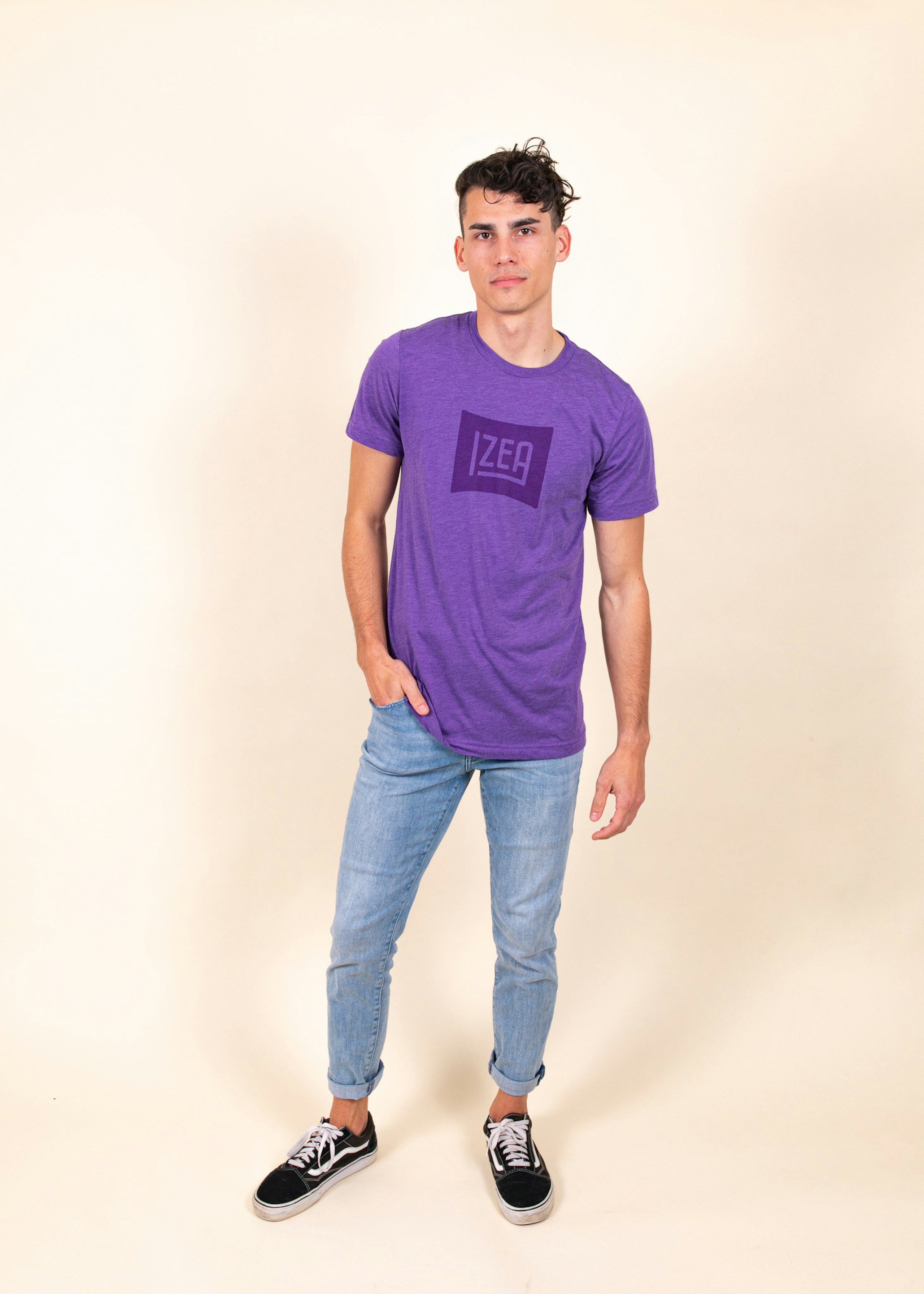 Man wearing purple t-shirt with tonal dark printing that says "Izea"
