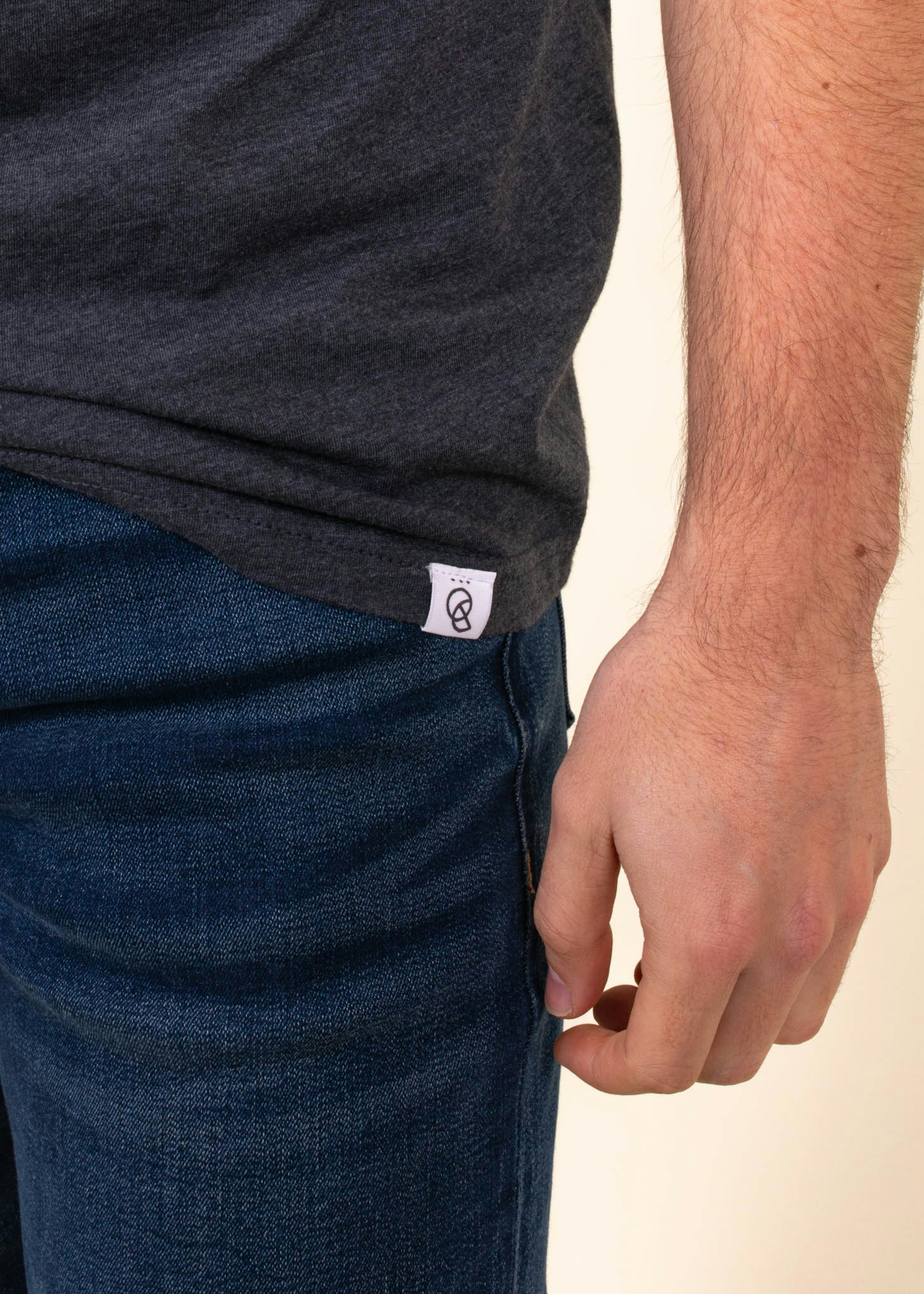 A custom hem tag is being worn on a man with jeans