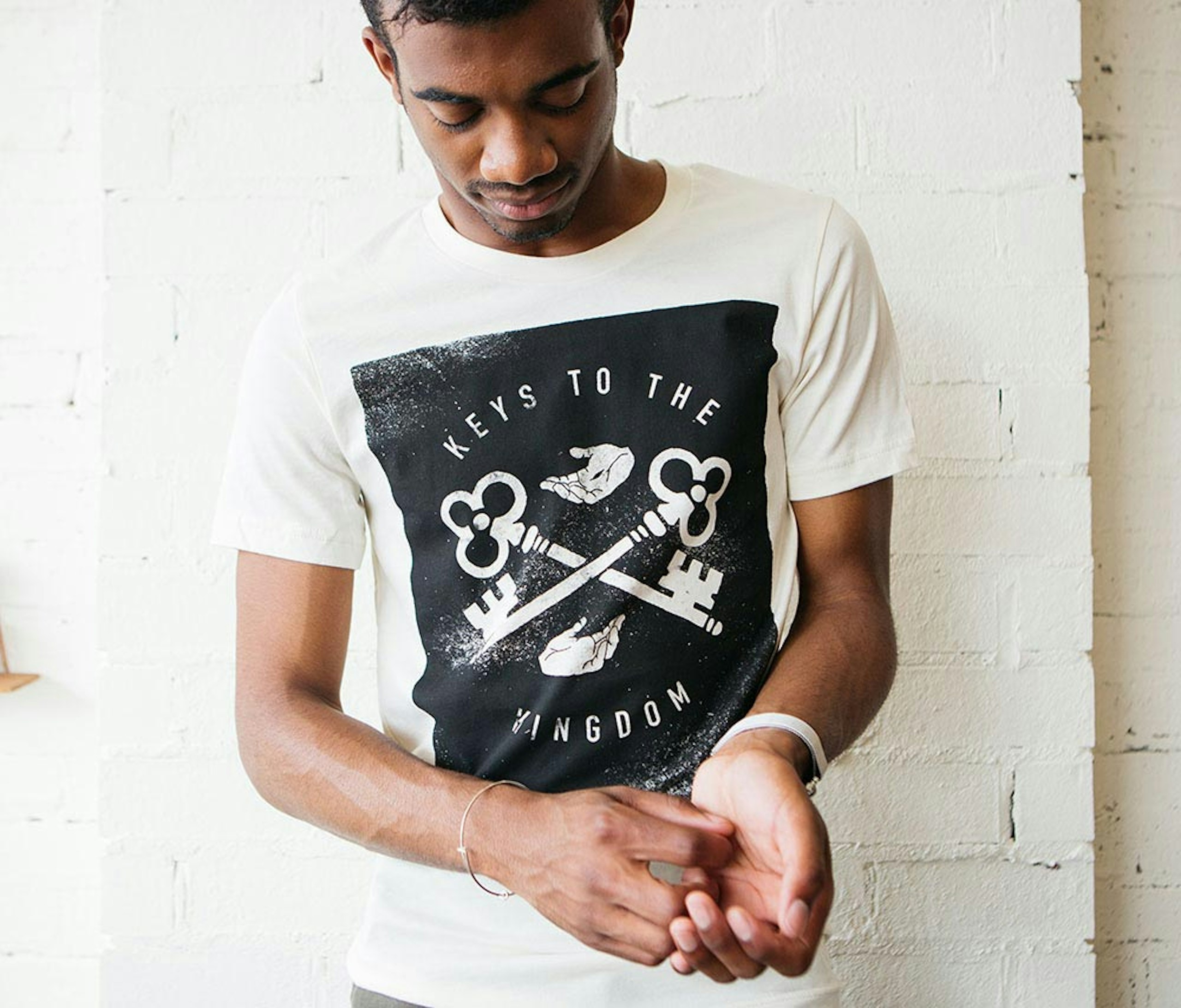 A man wears a shirt that says "keys to the kingdom," a custom church shirt 