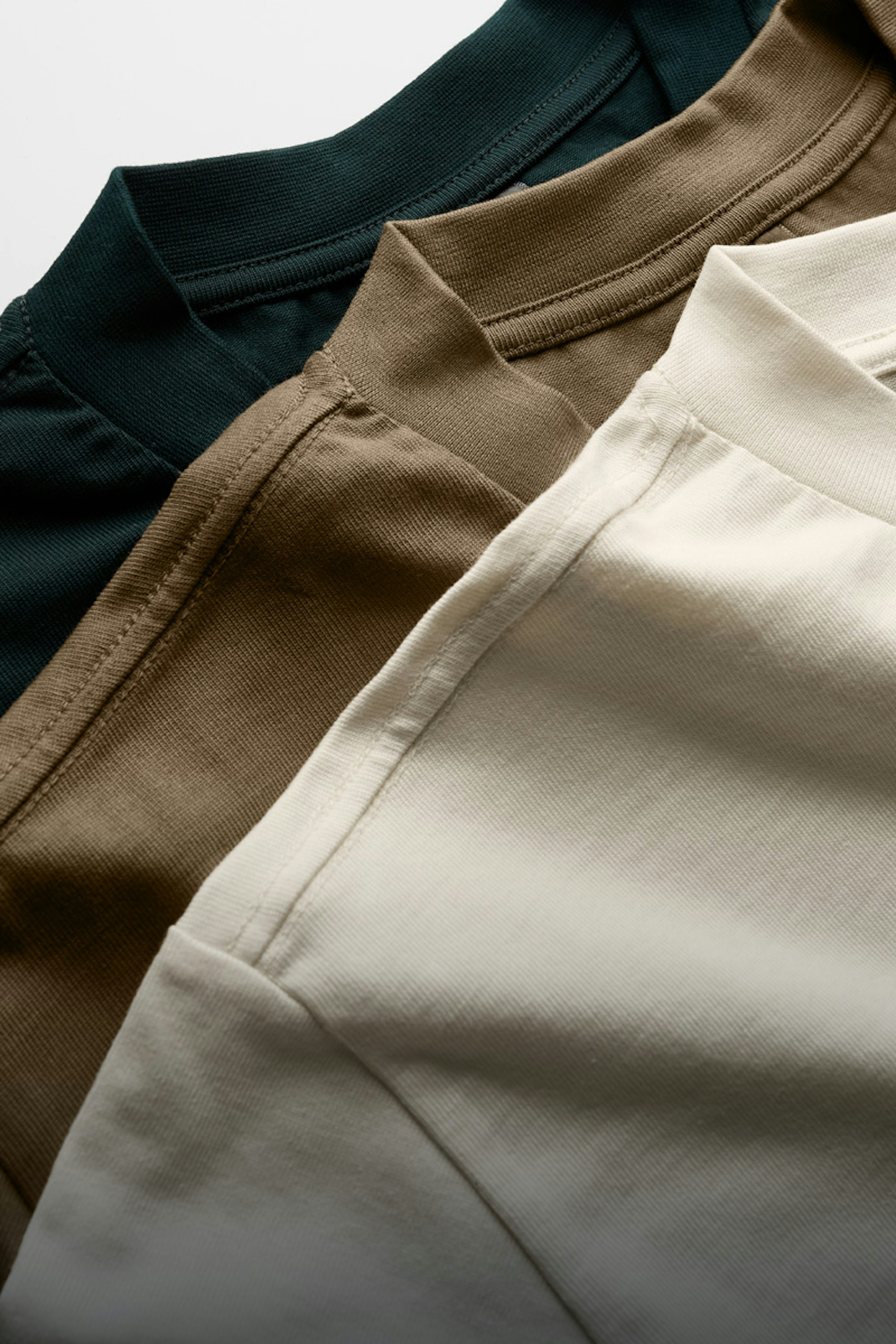 three t-shirts laying flat