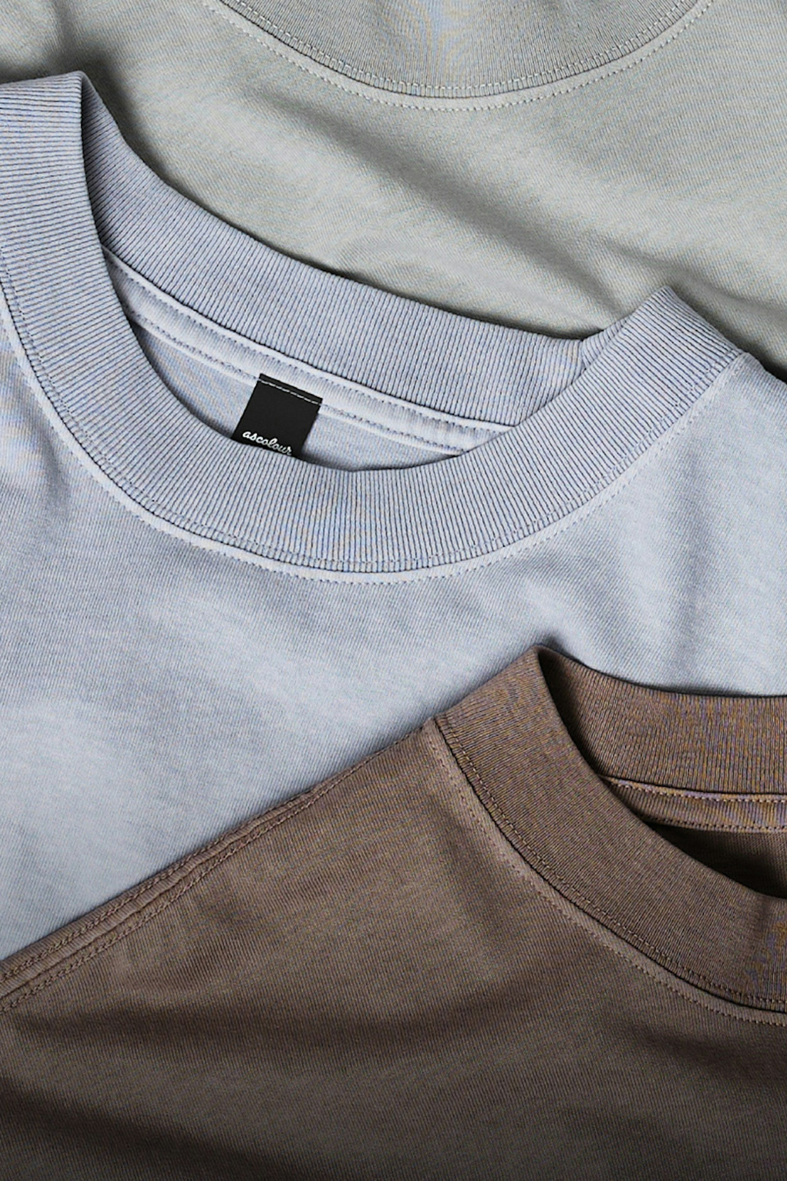 three t-shirts laying flat