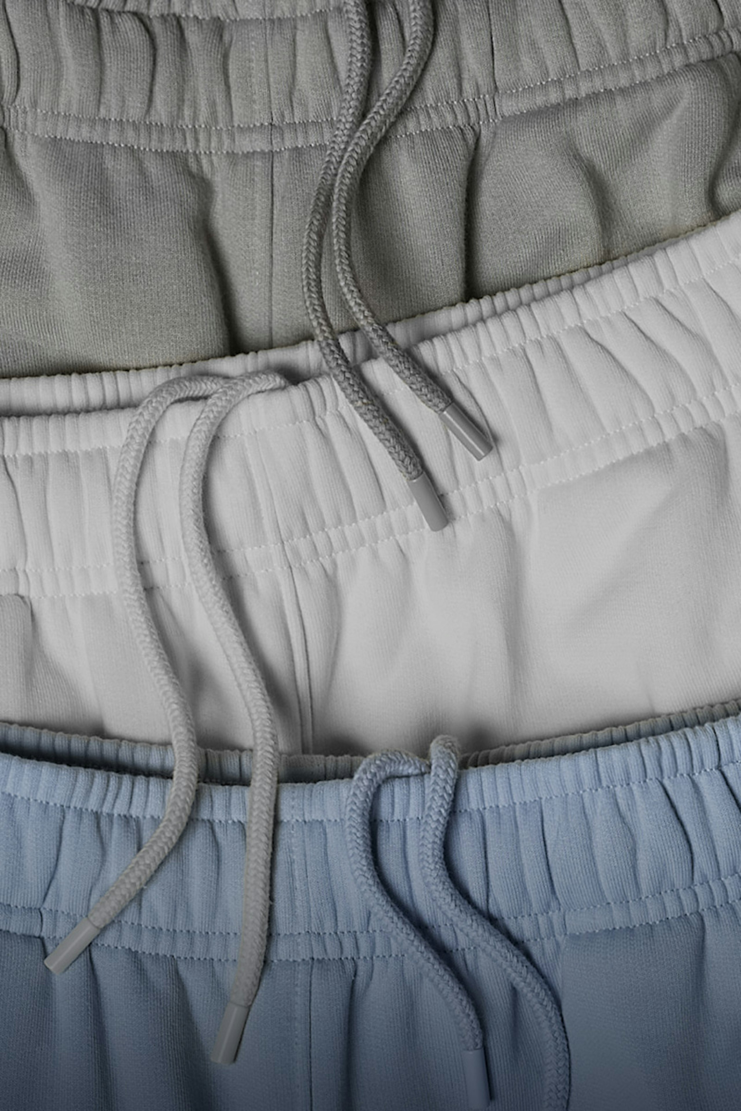 three pant waistbands laying flat on top of each other