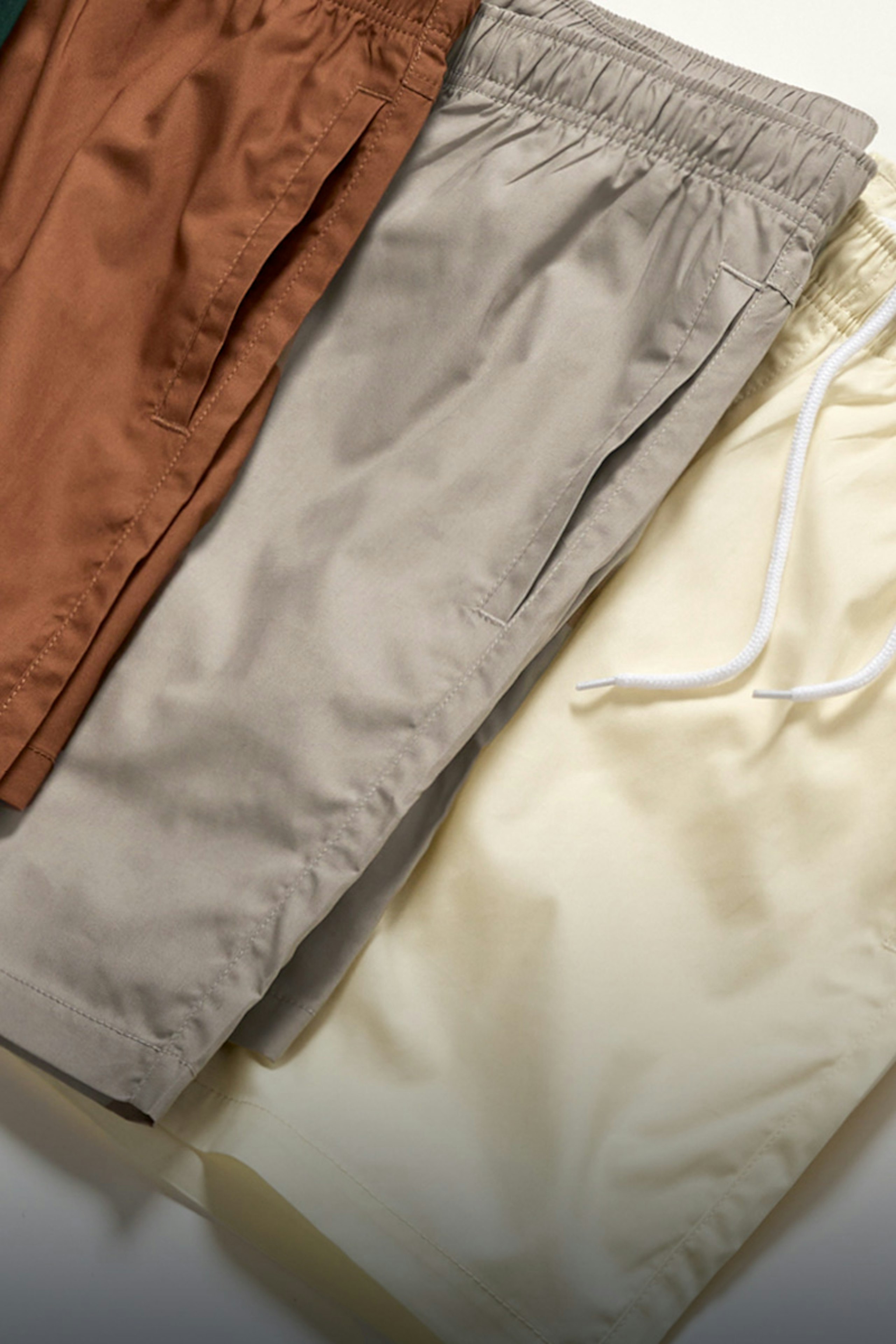 three shorts laying flat on top of each other