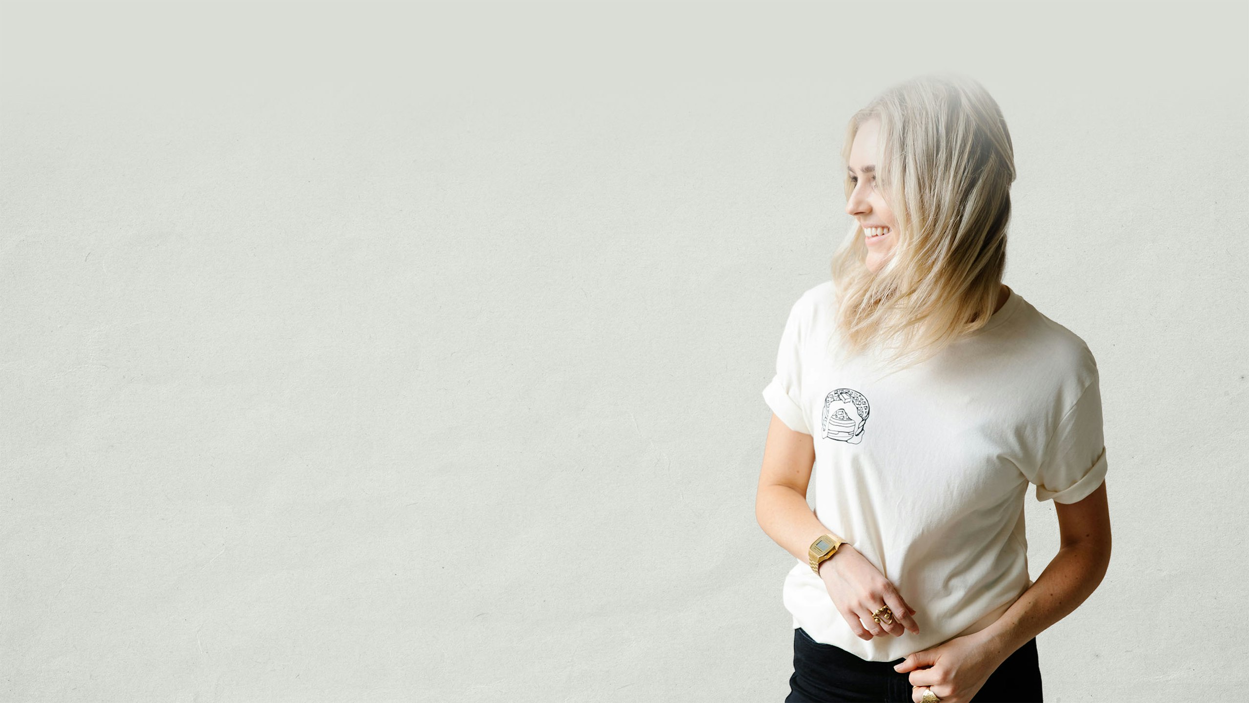 women wearing a bone color t-shirt with pancakes printing on the left pocket