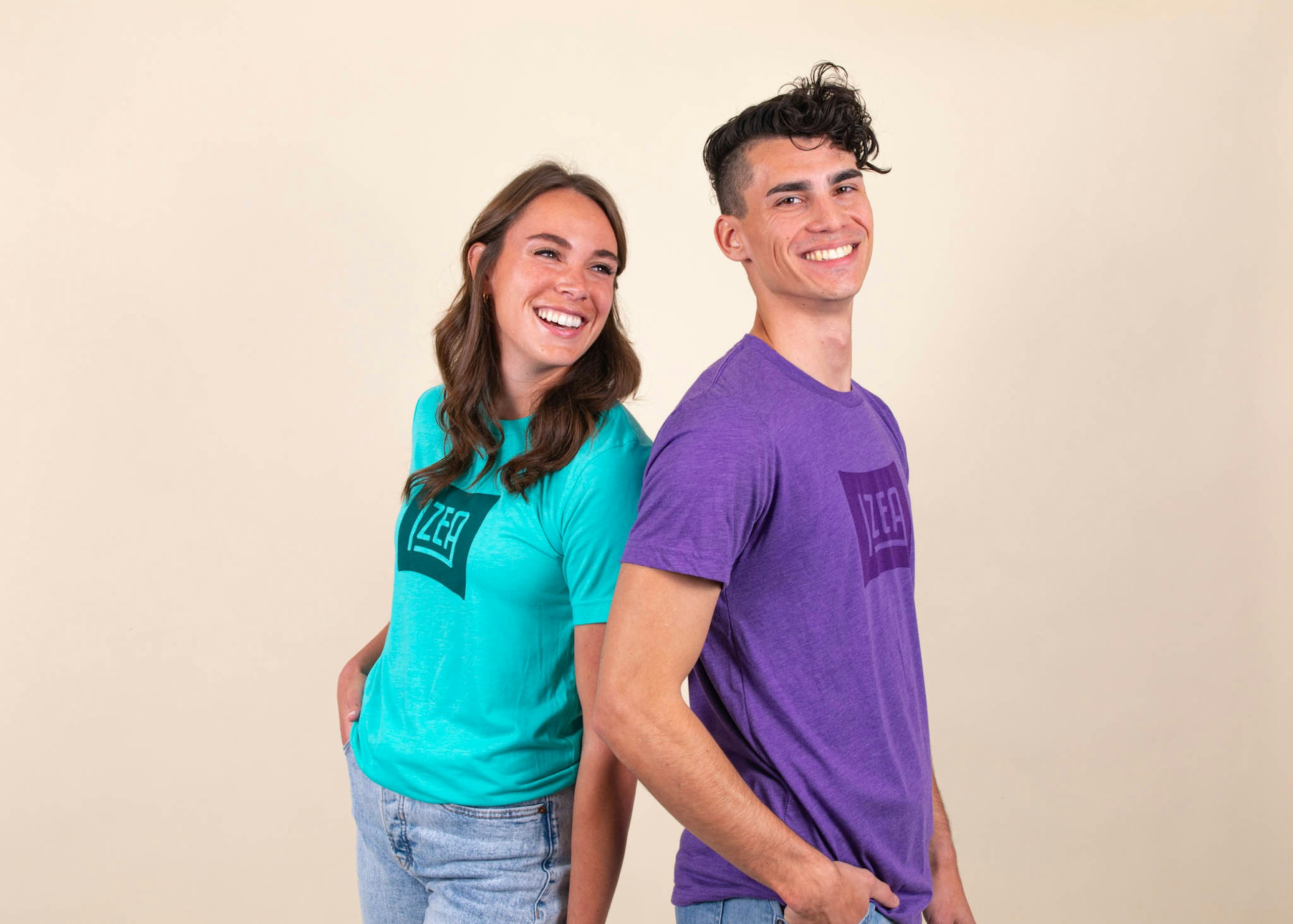 A woman and a man wear shirts in blue and purple, respectively, with a matching tonal design