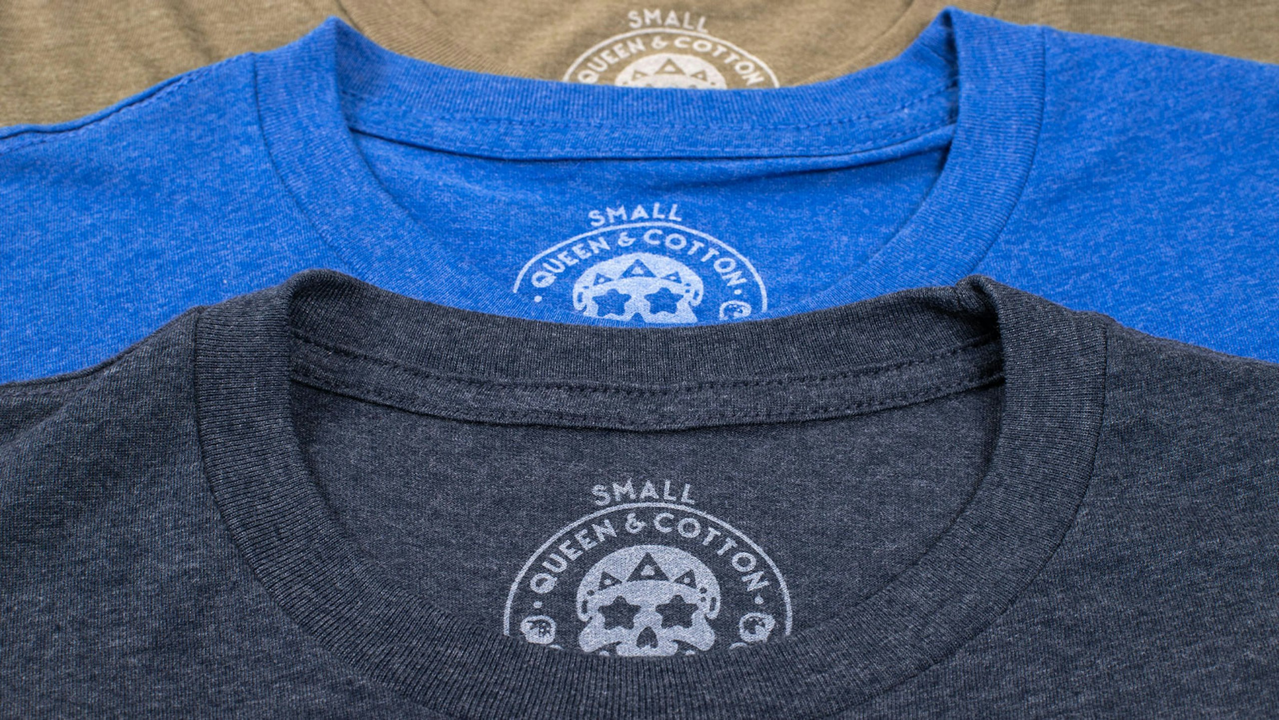 a close-up of three t-shirts printed tag