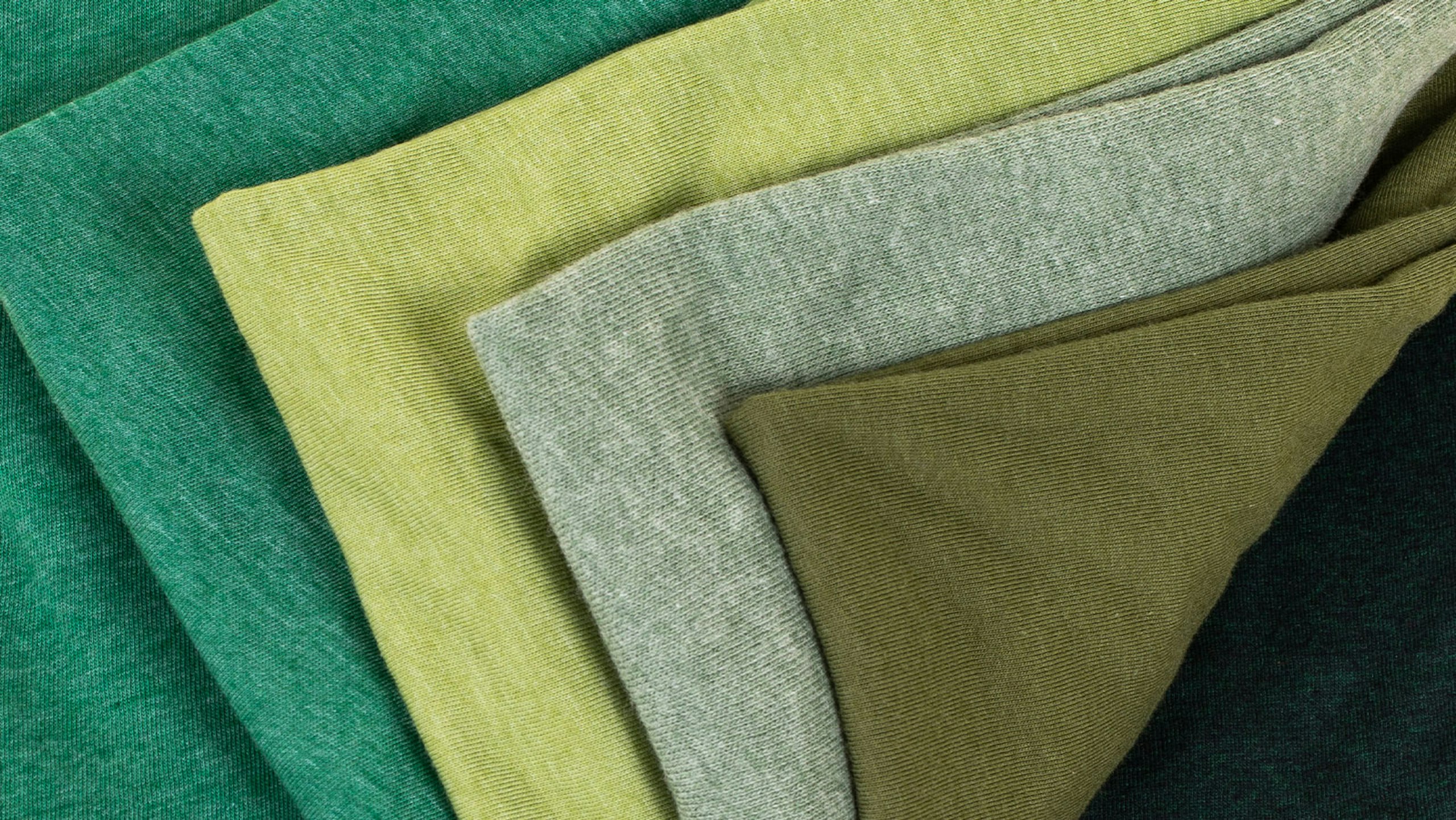 green shirts stacked on themselves