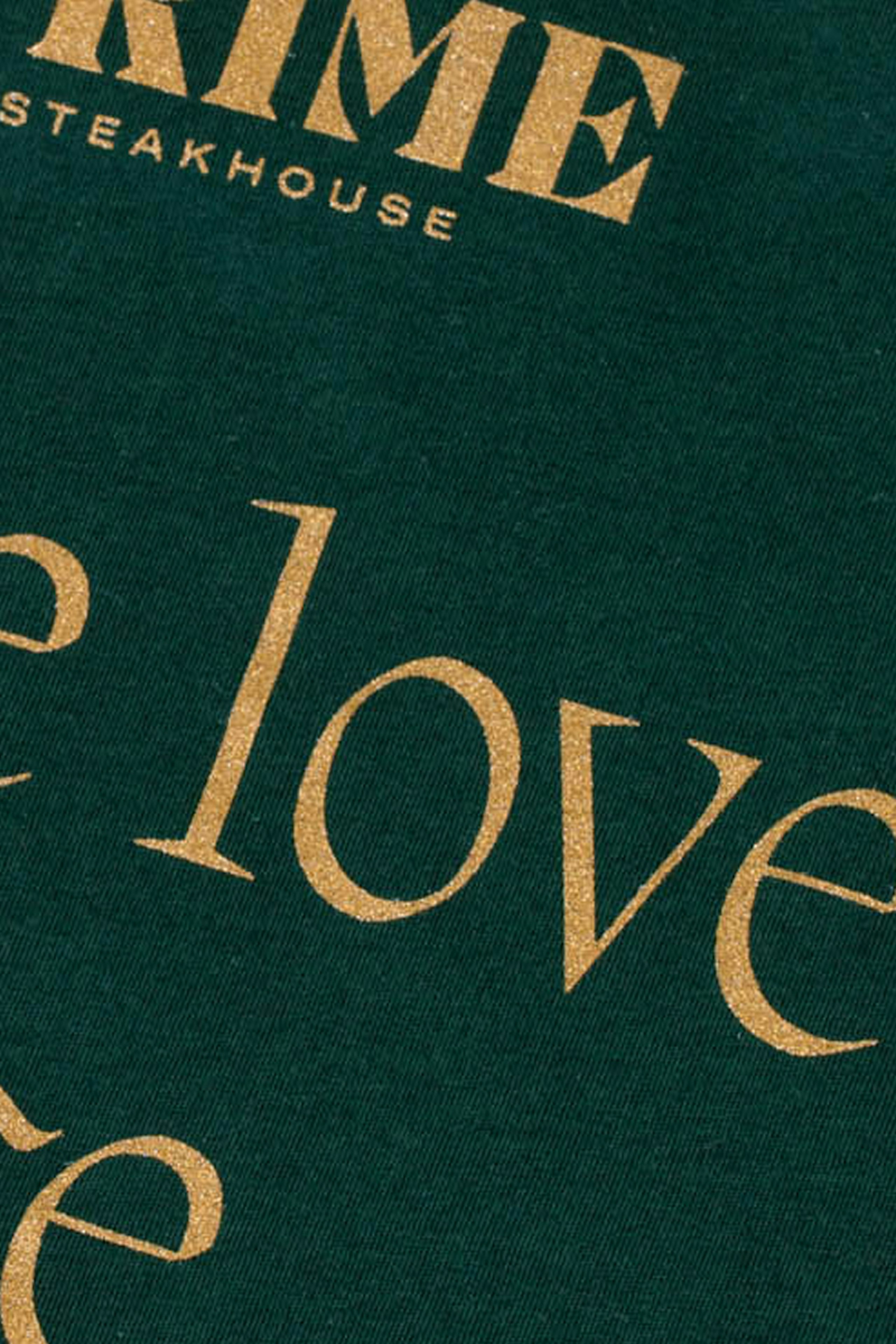close up of a green t-shirt with gold metallic ink