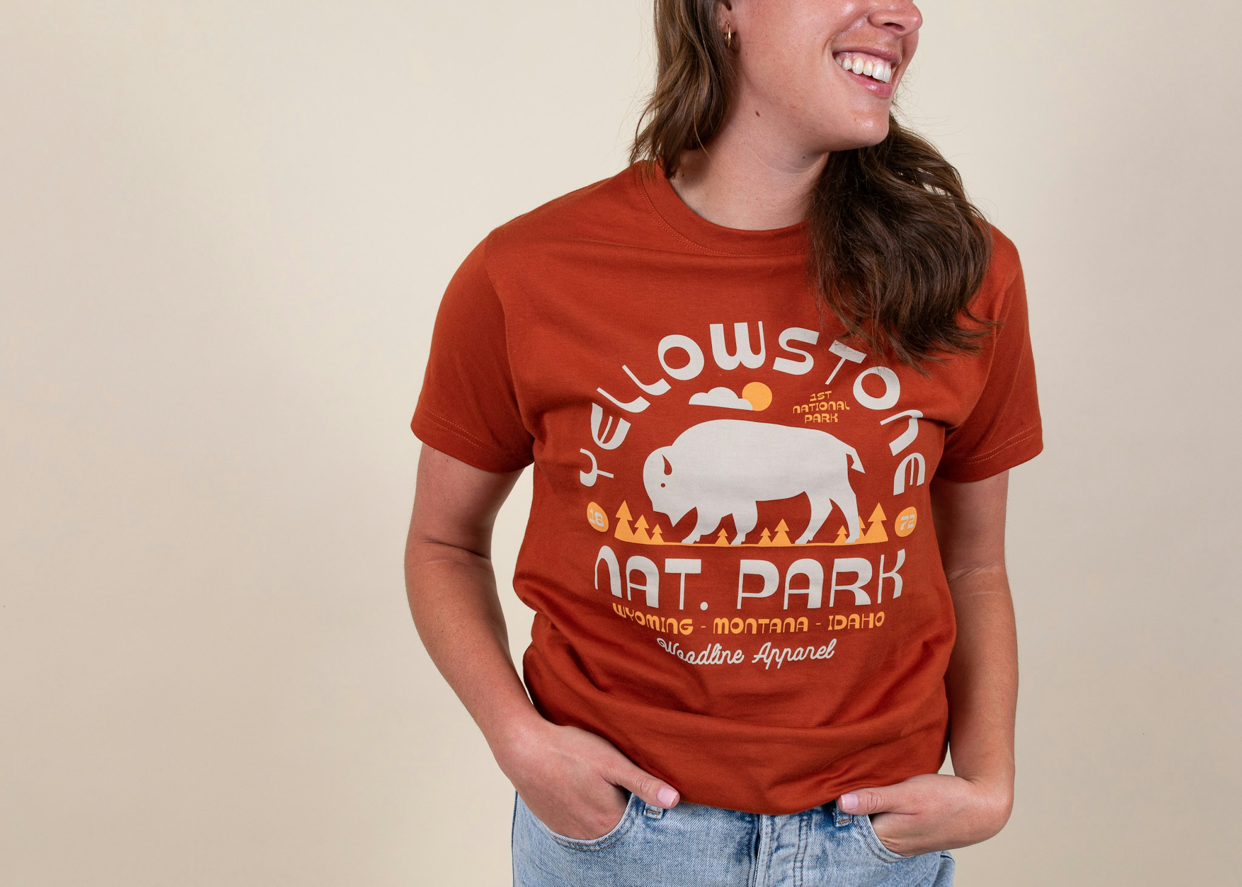 women wearing an orange t-shirt with yellowstone nat. park printed on it