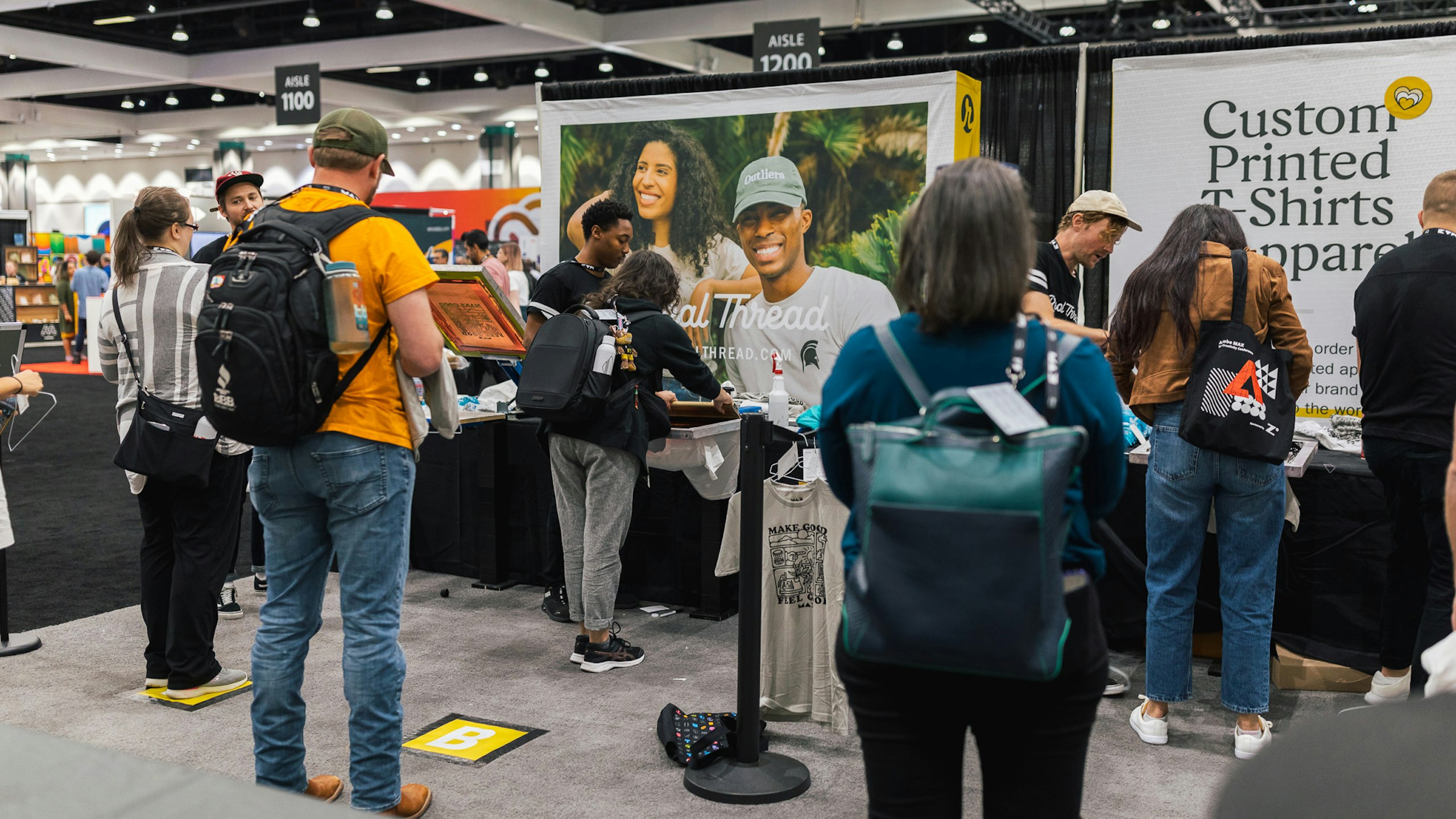 a bunch of people standing in a booth at a tradeshow