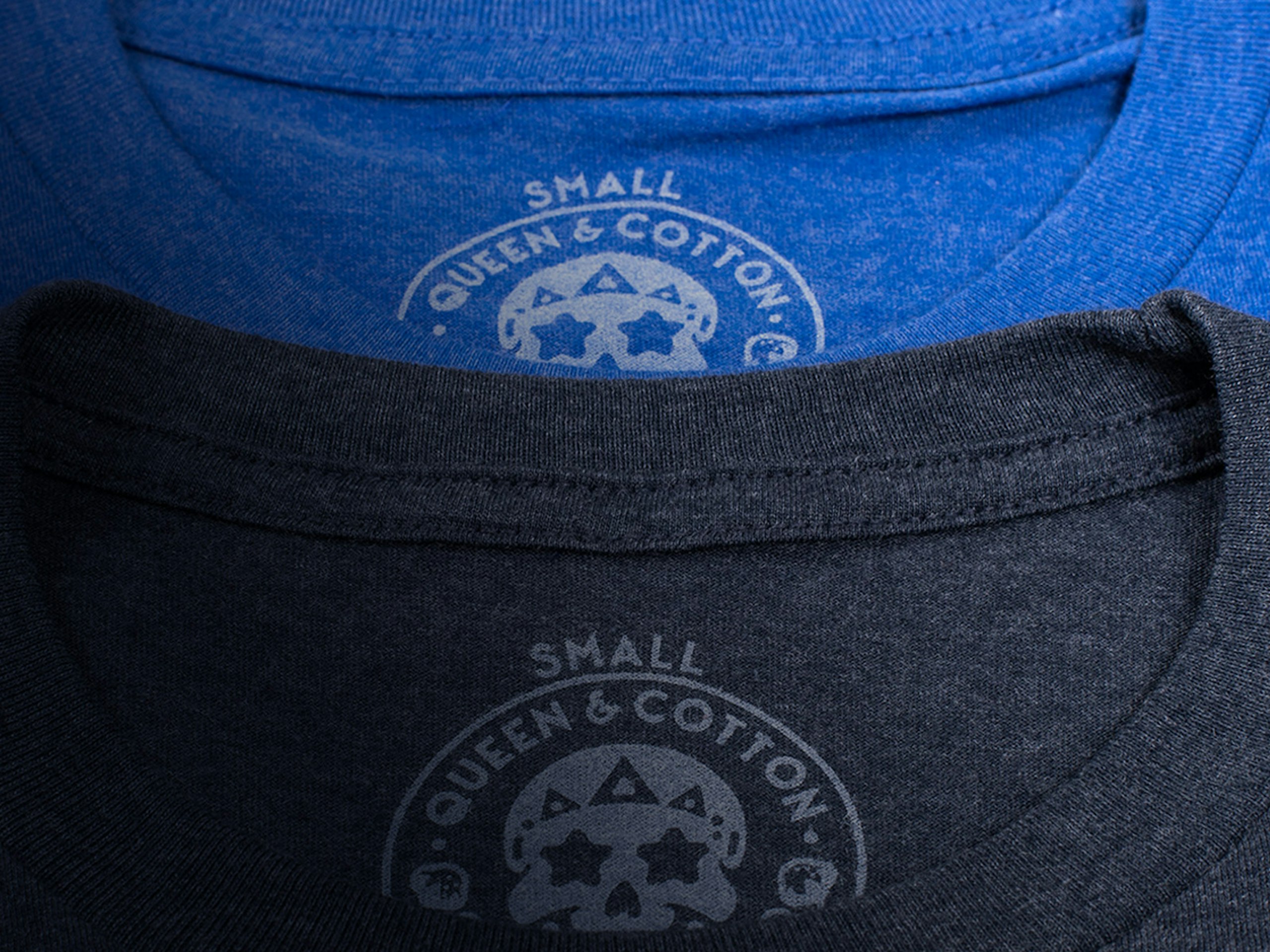 close up of two printed tags on a blue and grey t-shirt