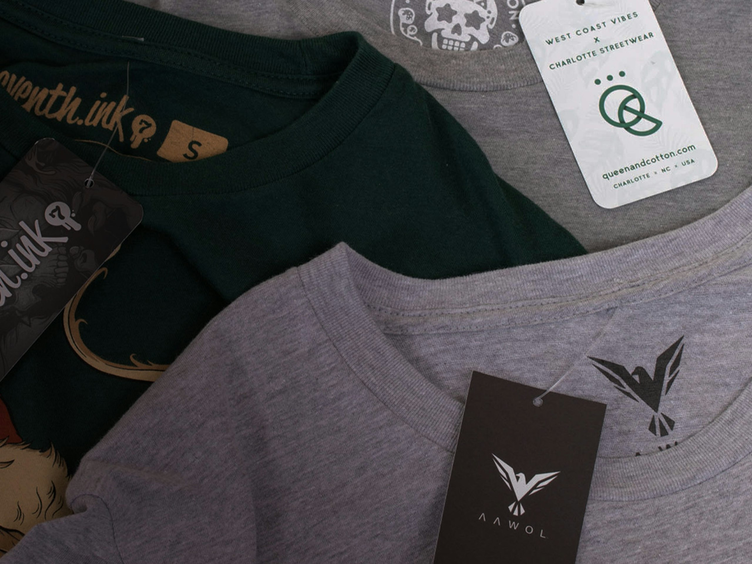 several t-shirts laying flat with hang tags