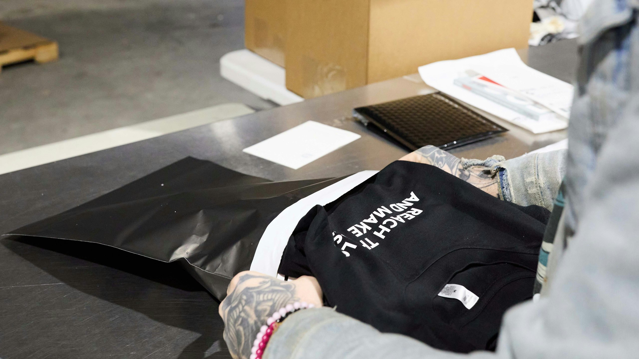 someone bagging a shirt to ship