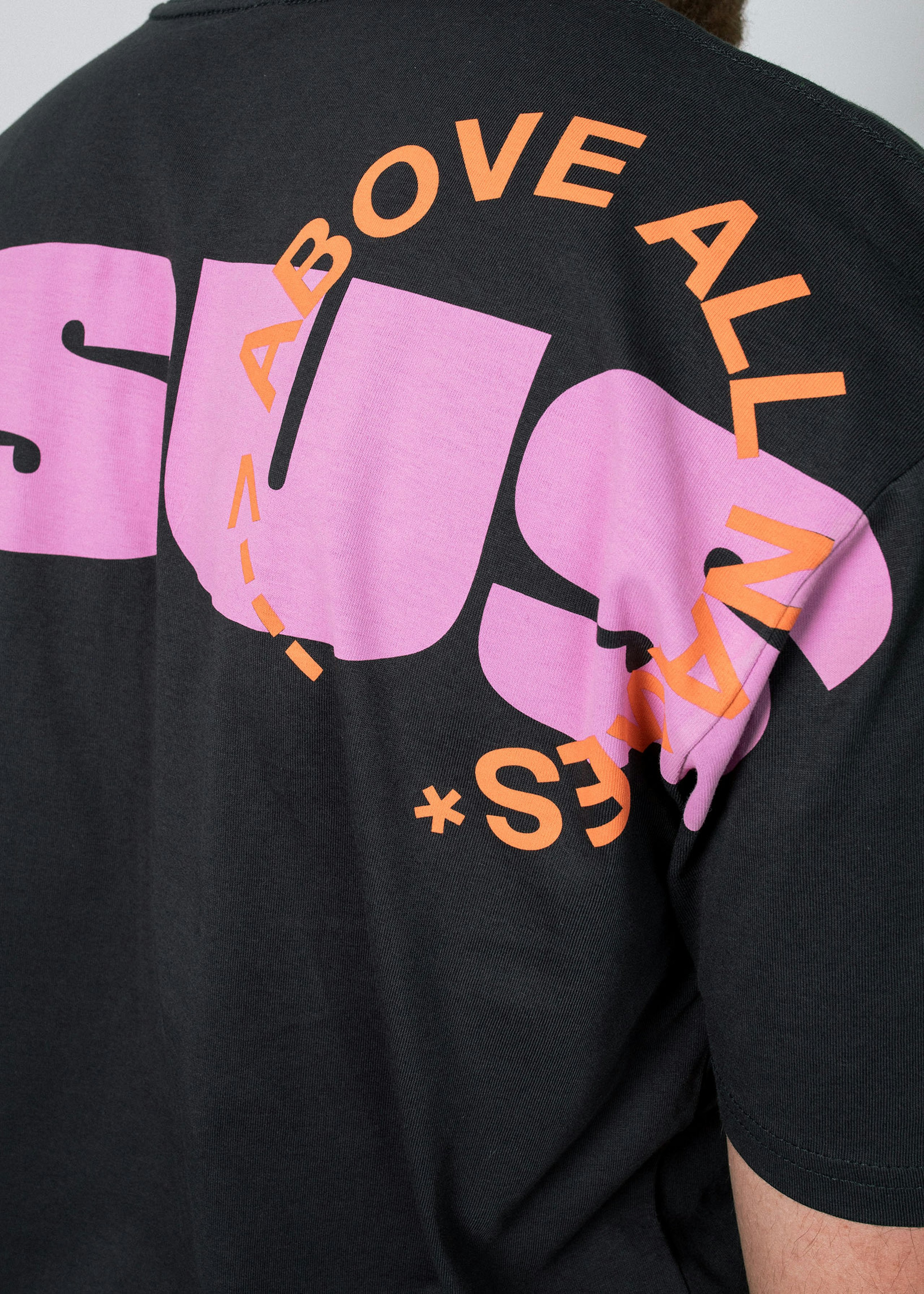 close up of a pink print going over the seams of a t-shirt