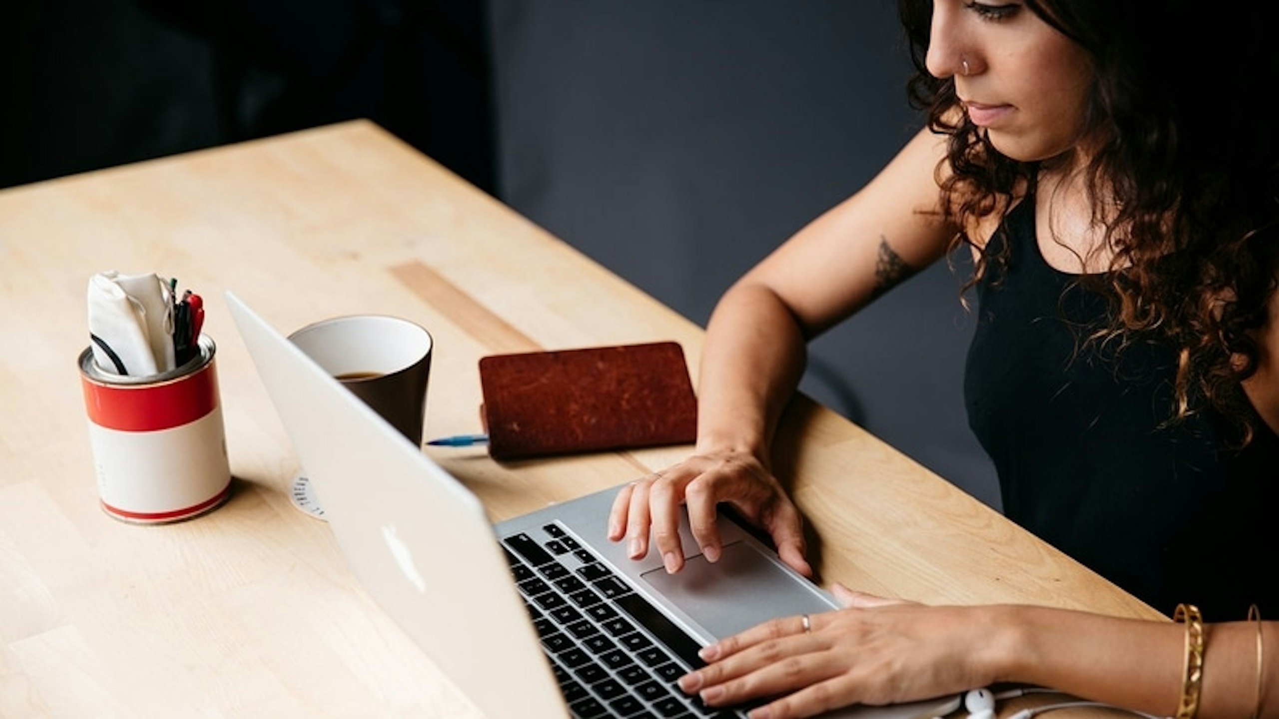women sitting at a table with a laptop