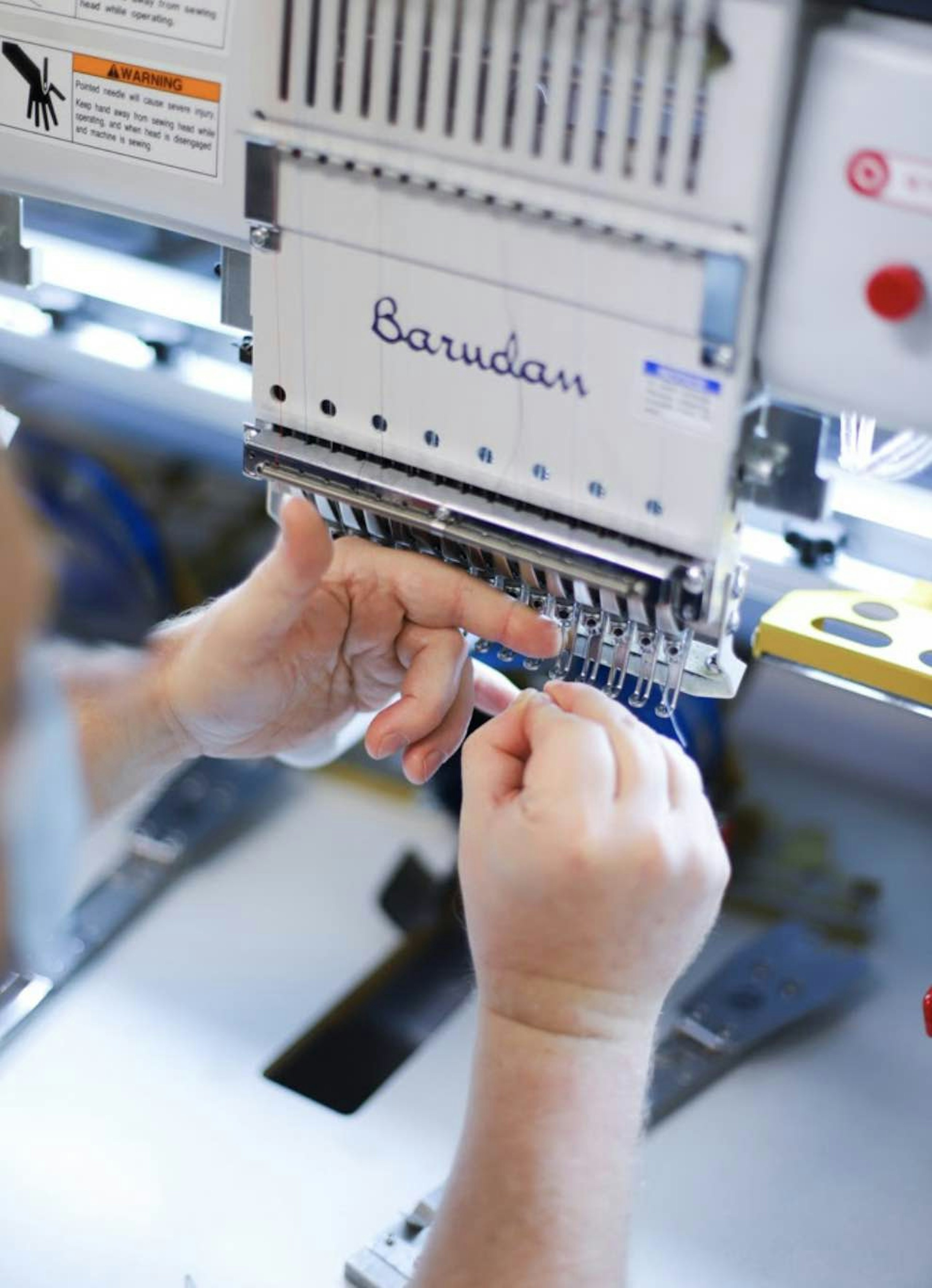 close up of someone prepping the embroidery machine