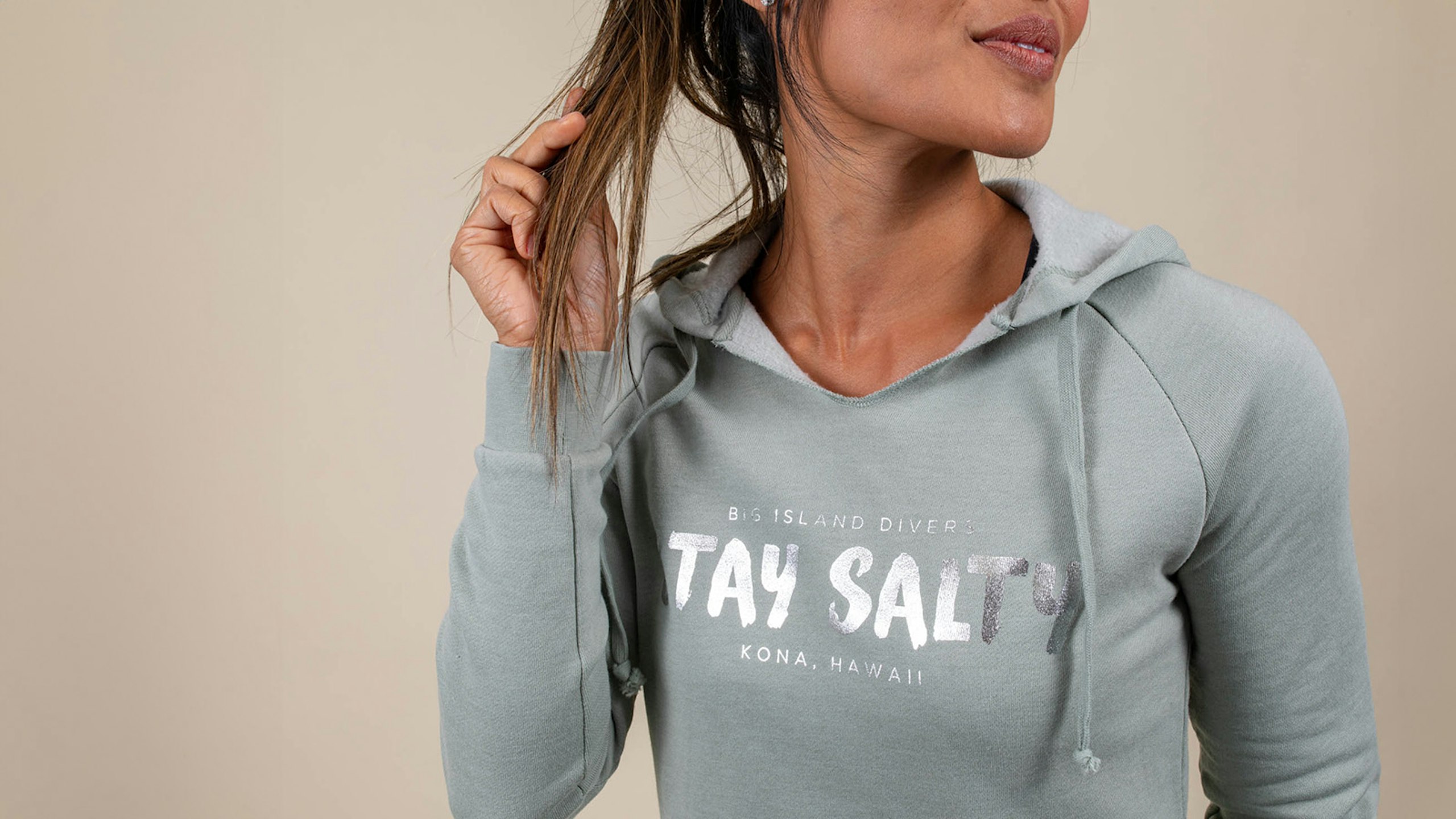 women wearing sea green hoodie with silver metallic ink