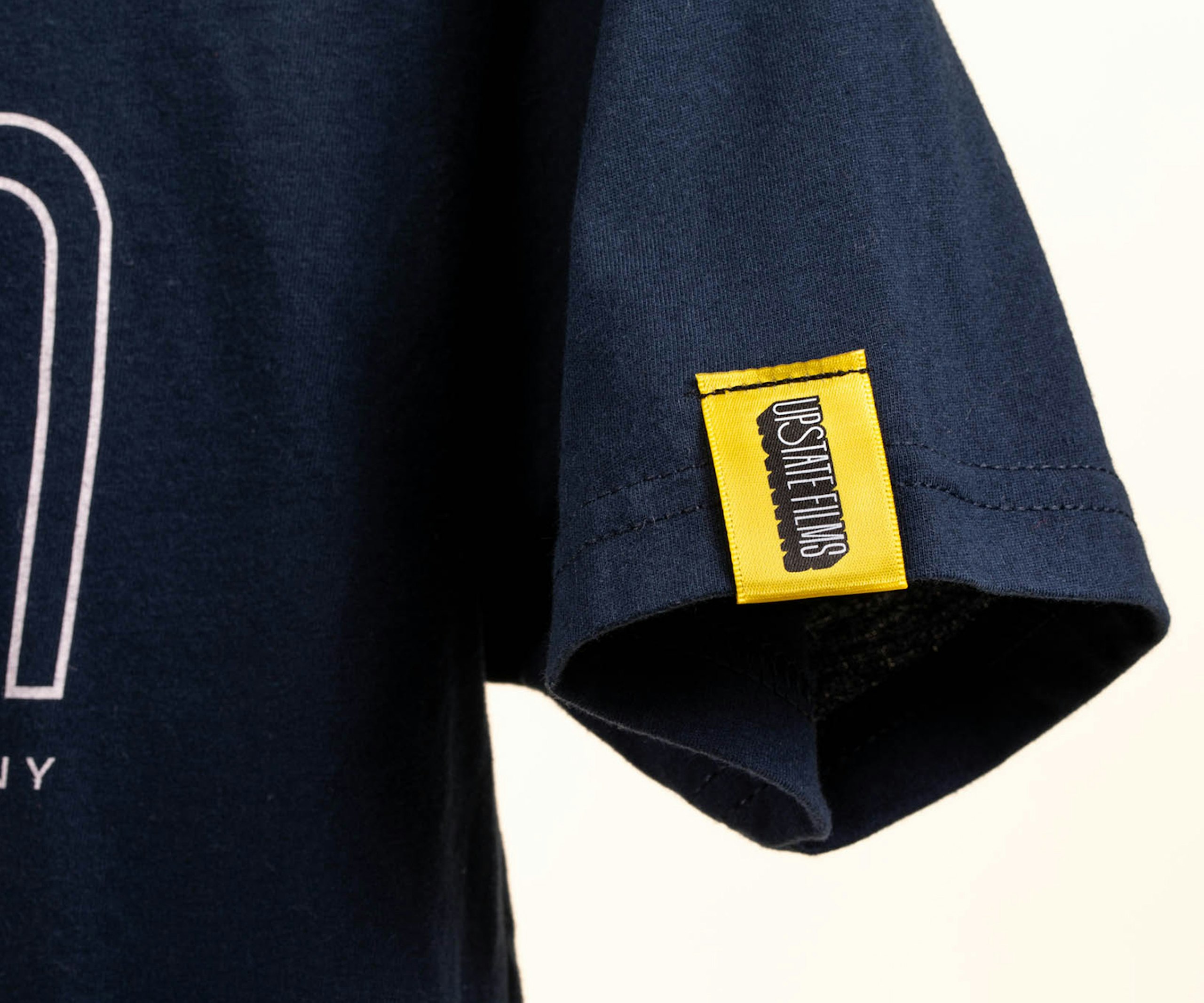 yellow hem tag on the sleeve of a navy t-shirt