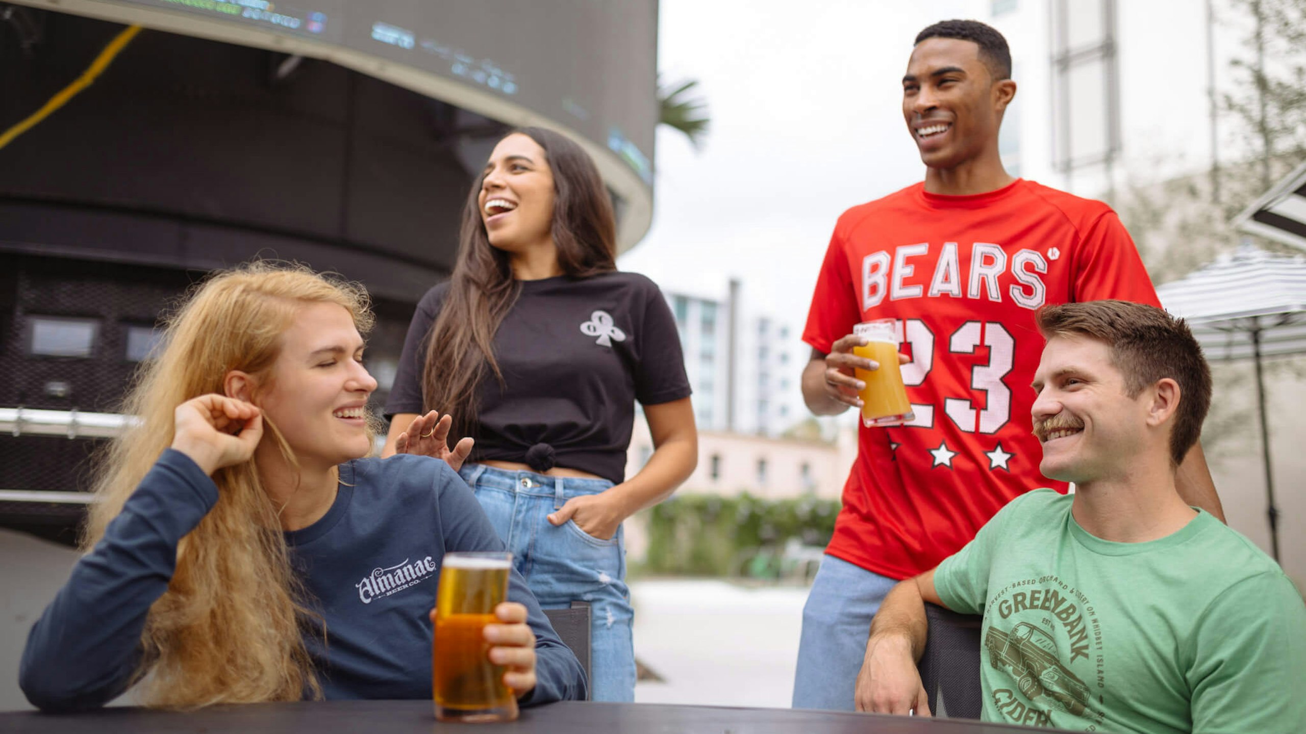 four people together drinking beer