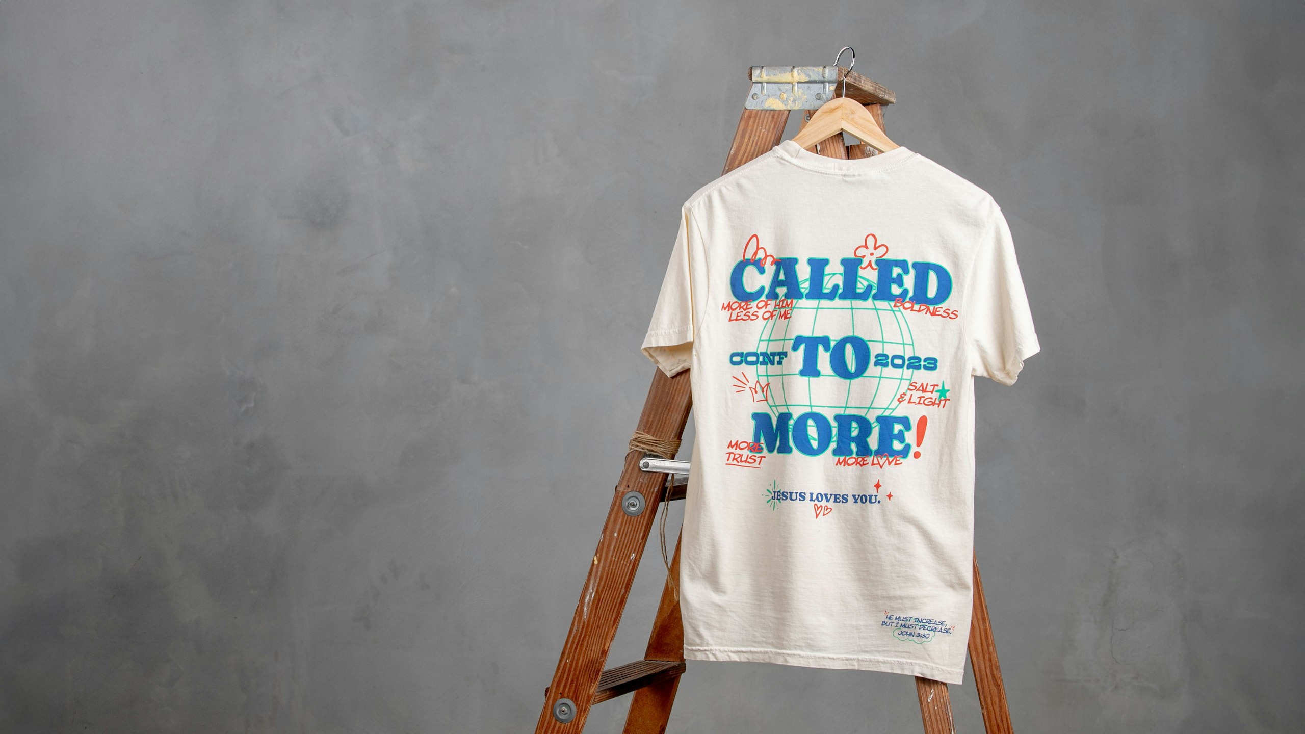 white t-shirt hanging on a ladder