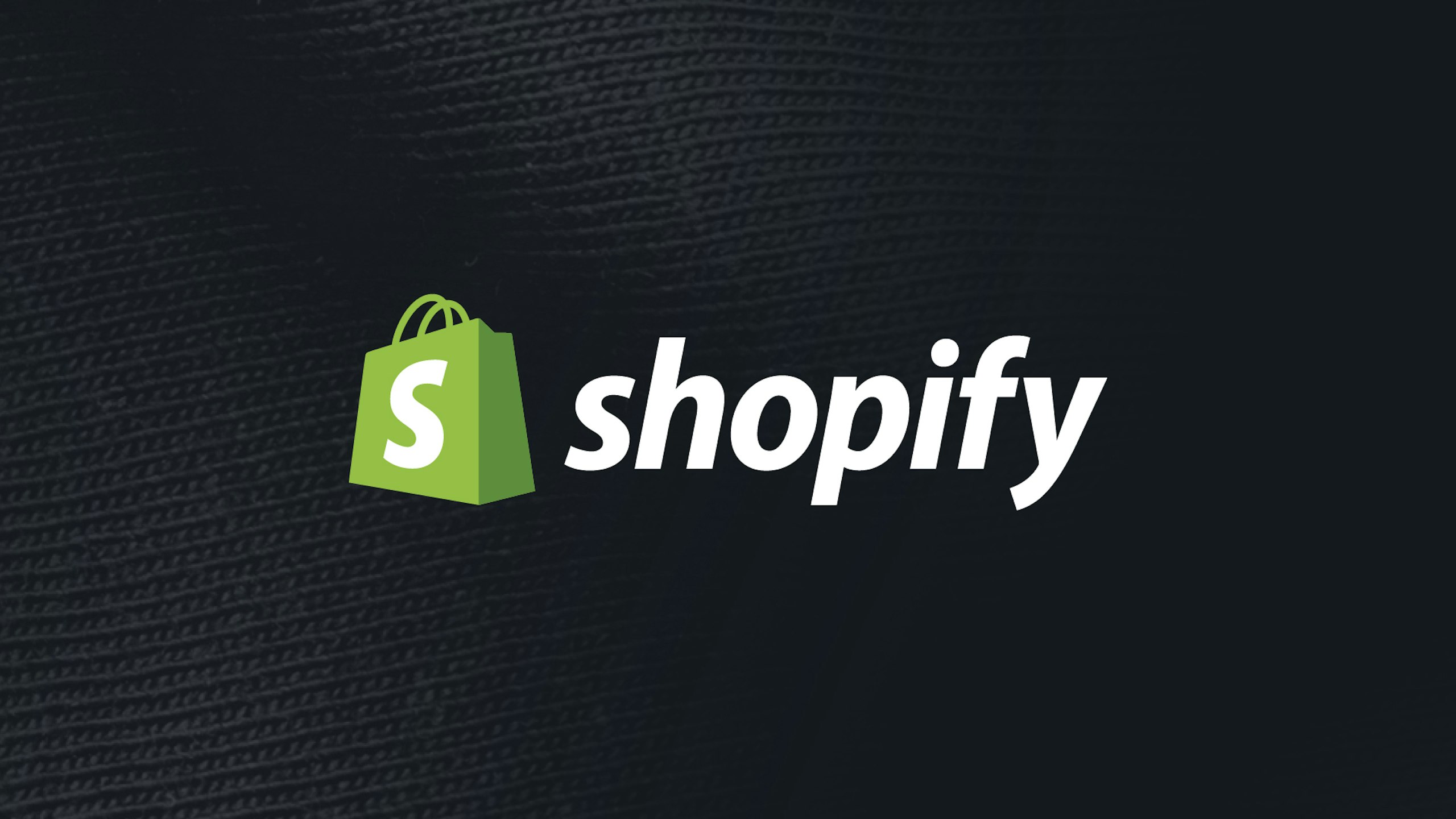 Shopify logo on a black fabric background