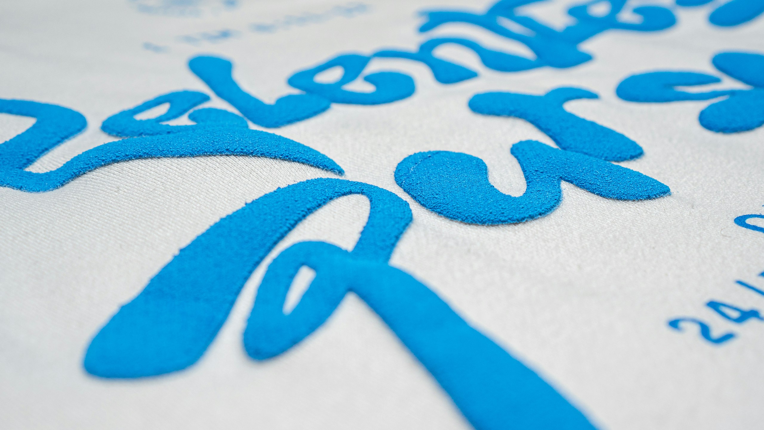 close-up on blue puff print on a white fleece