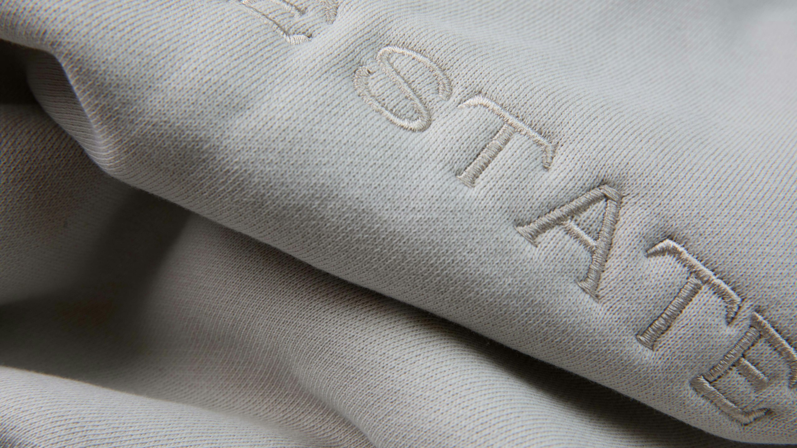 close-up of a white hoodie that is embroidered