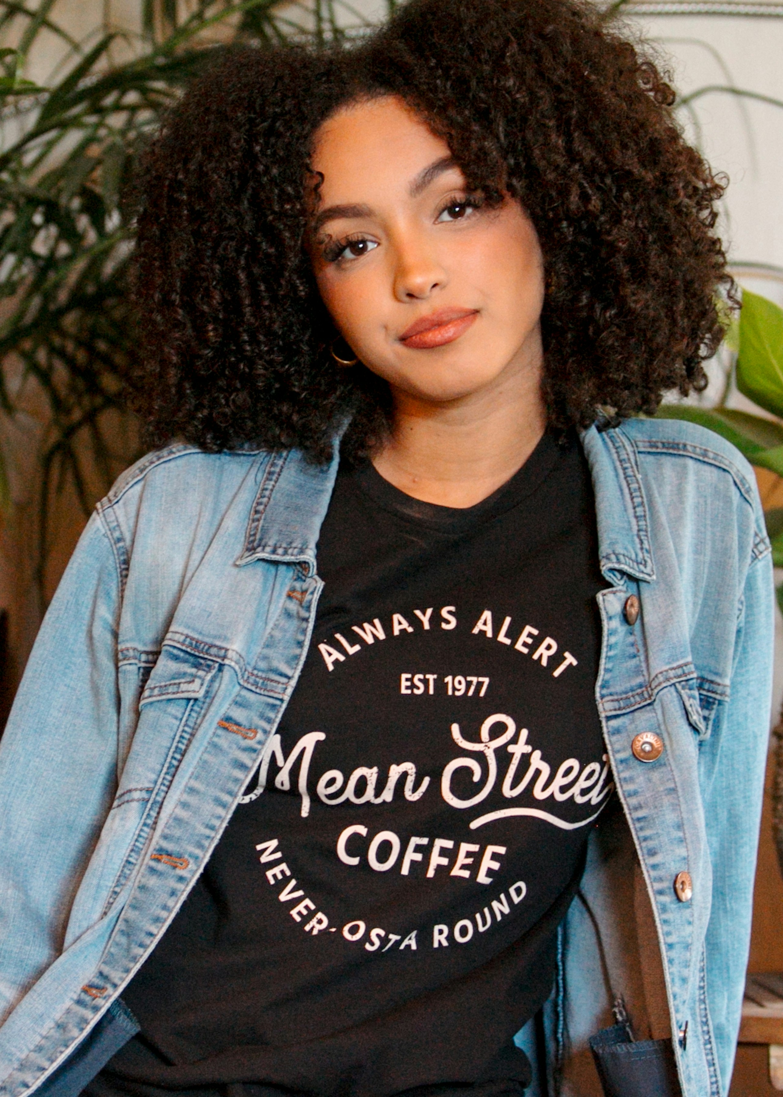 woman wearing a black t-shirt with a jean jacket