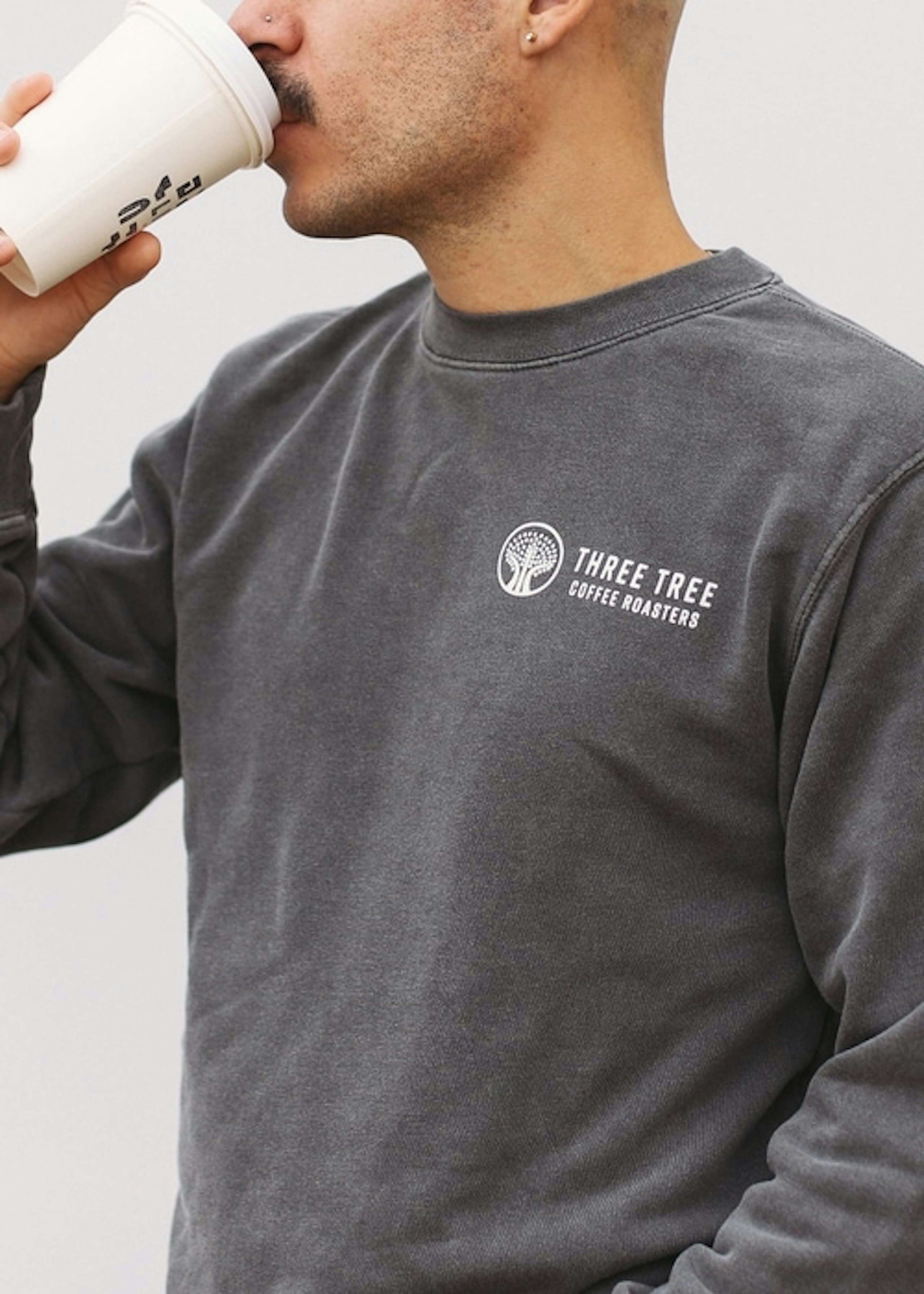 man wearing a gray crewneck sweatshirt